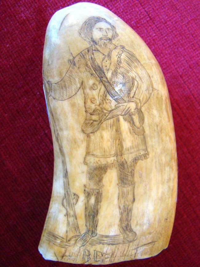 A 19th century Scrimshaw whale's tooth depicting a Frontiersman holding a Kentucky rifle circa 1858